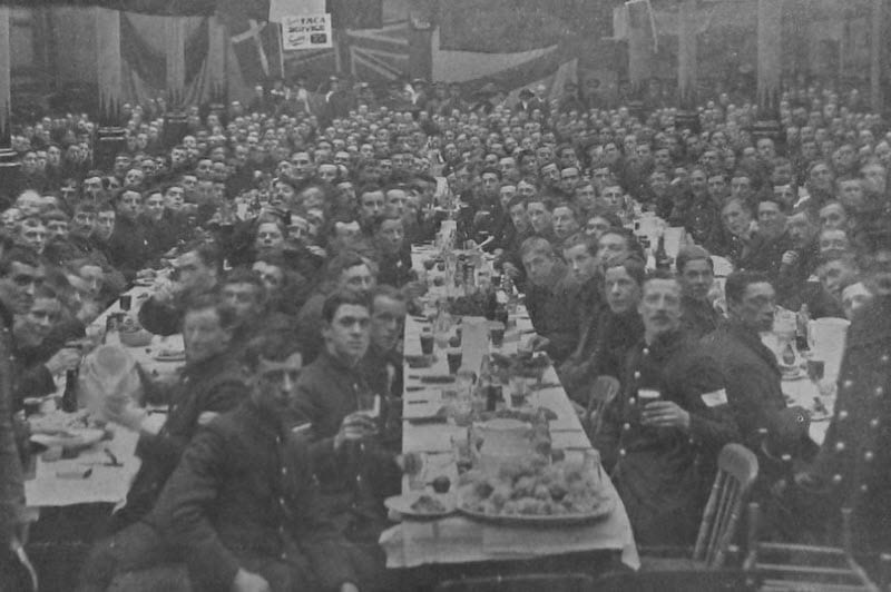 The men of the 7th Battalion Royal Berkshire Regiment sit down to their dinner at the Corn Exchange